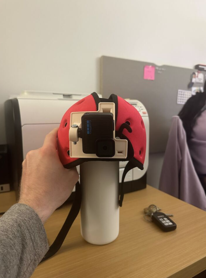 The current BabyView camera mounted on a child-safety helmet